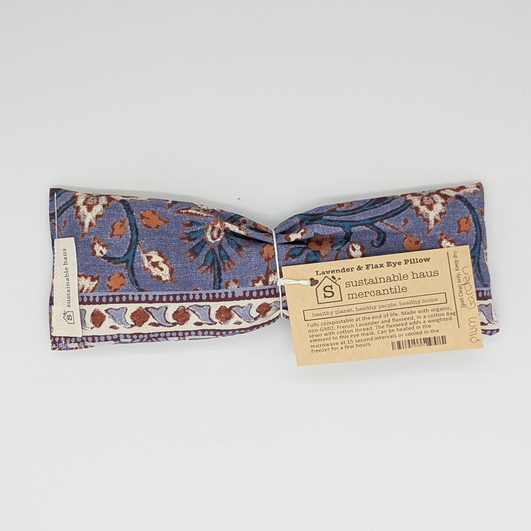 Flax eye pillow with floral pattern and 'Sustainable haus mercantile' tag on a white background

