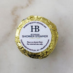 shower steamer wrapped in yellow recyclable foil lemon + mint
